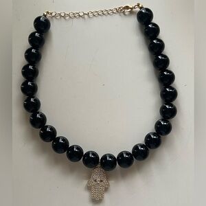 Elegant Black Beaded Necklace with Gold Hamsa Pendant